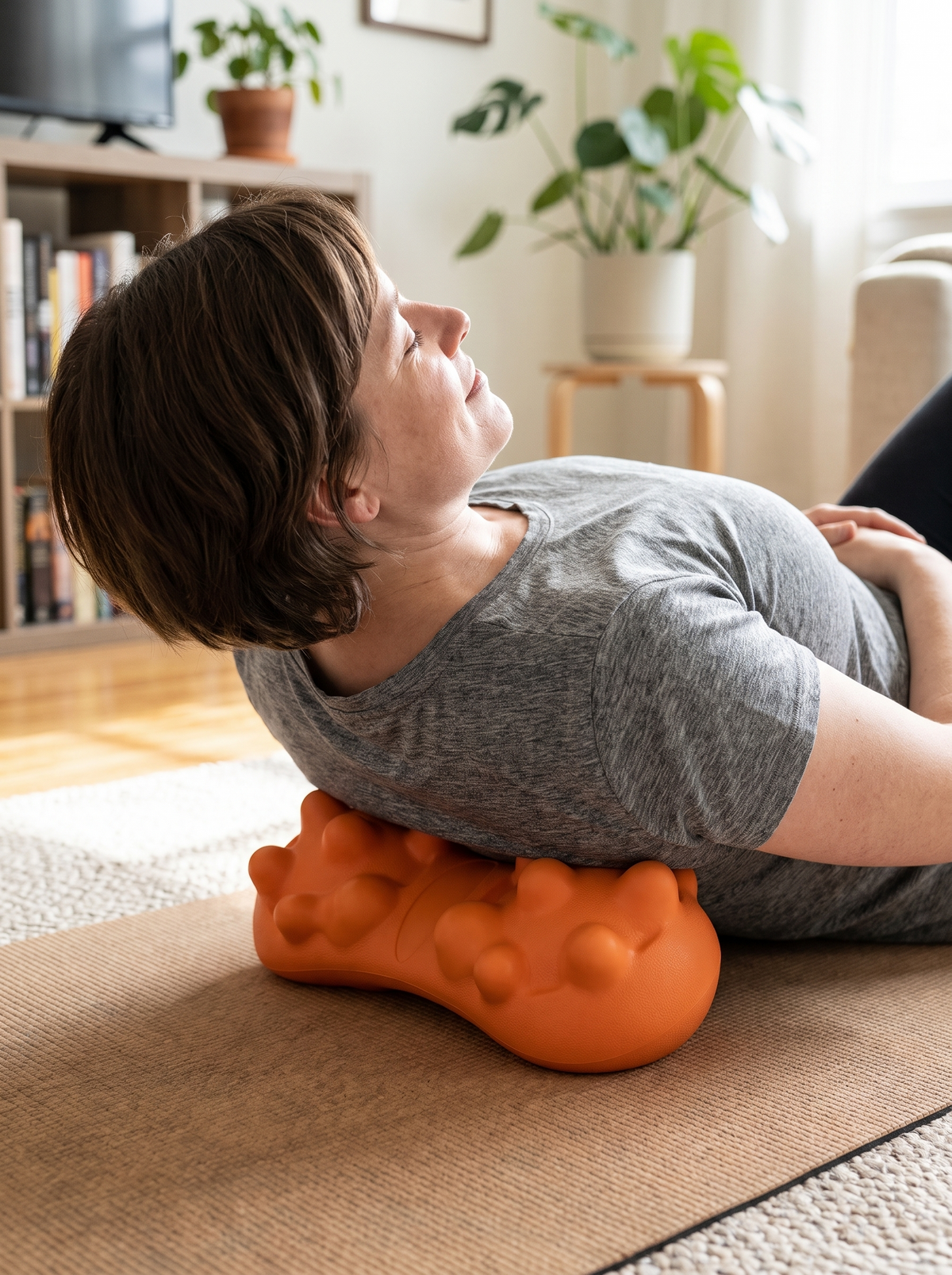 Trigger point tool in use under the upper back
